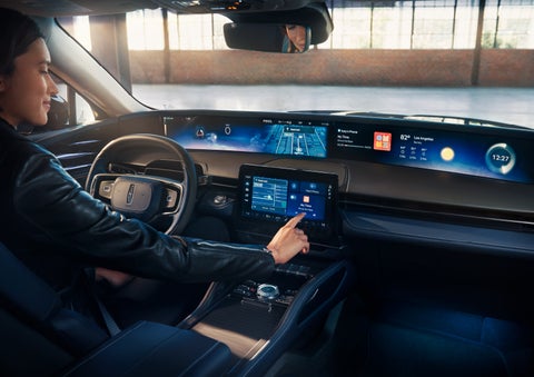 The driver of a 2024 Lincoln Nautilus® SUV interacts with the center touchscreen. | Seekins Lincoln in Fairbanks AK