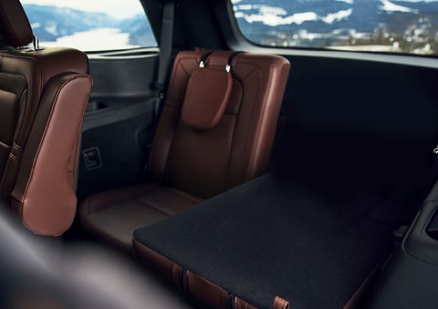 The left rear seat of a 2024 Lincoln Aviator® SUV is shown folded flat for additional cargo space | Seekins Lincoln in Fairbanks AK