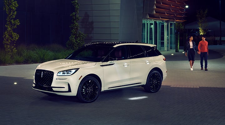 Two people approach a 2024 Lincoln Corsair® SUV featuring the available Jet Appearance Package. | Seekins Lincoln in Fairbanks AK