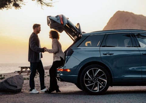 A couple share a moment together outside a 2025 Lincoln Corsair® SUV near the open liftgate. | Seekins Lincoln in Fairbanks AK
