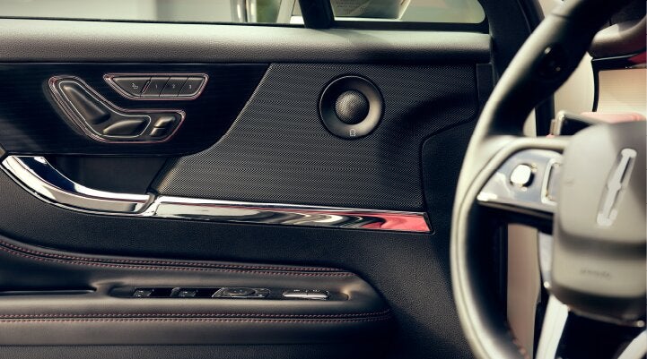 A Revel® audio speaker is shown in the driver's side door of a 2025 Lincoln Corsair® SUV. | Seekins Lincoln in Fairbanks AK