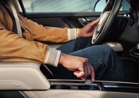 The driver of a 2024 Lincoln Corsair® SUV is shown selecting the drive mode. | Seekins Lincoln in Fairbanks AK