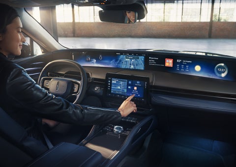 The driver of a 2026 Lincoln Nautilus® SUV interacts with the center touchscreen. | Seekins Lincoln in Fairbanks AK