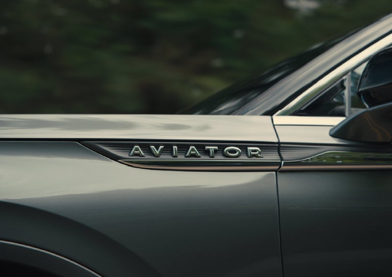 The driver’s side door and fender badging of a gray 2027 Lincoln Aviator® SUV are showcased. | Seekins Lincoln in Fairbanks AK