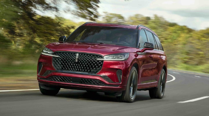 A 2027 Lincoln Aviator® SUV is being driven on a country road | Seekins Lincoln in Fairbanks AK