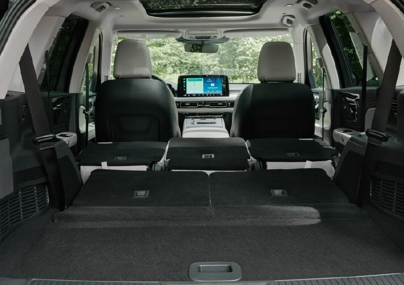 A rear to front view of the interior of a 2027 Lincoln Aviator® Black Label™ SUV shows the third and second rows folded flat | Seekins Lincoln in Fairbanks AK