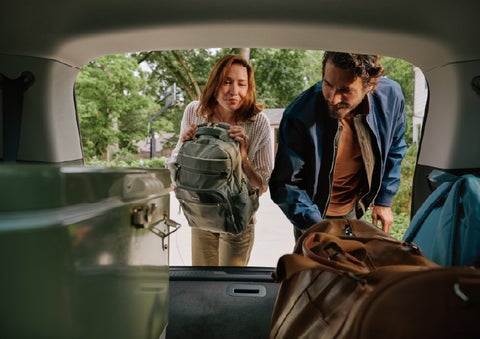 A couple loads luggage into the rear of a 2027 Lincoln Aviator® Black Label™ SUV..e 202 | Seekins Lincoln in Fairbanks AK