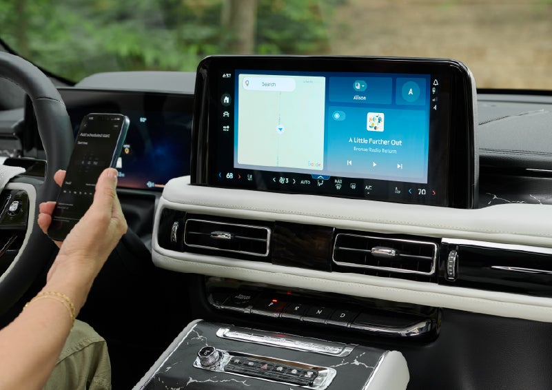 A person pairs thier phone with the center touchscreen of a 2027 Lincoln Aviator® Black Label™ SUV | Seekins Lincoln in Fairbanks AK